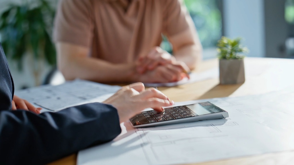 Homebuyers reviewing property costs and financial documents