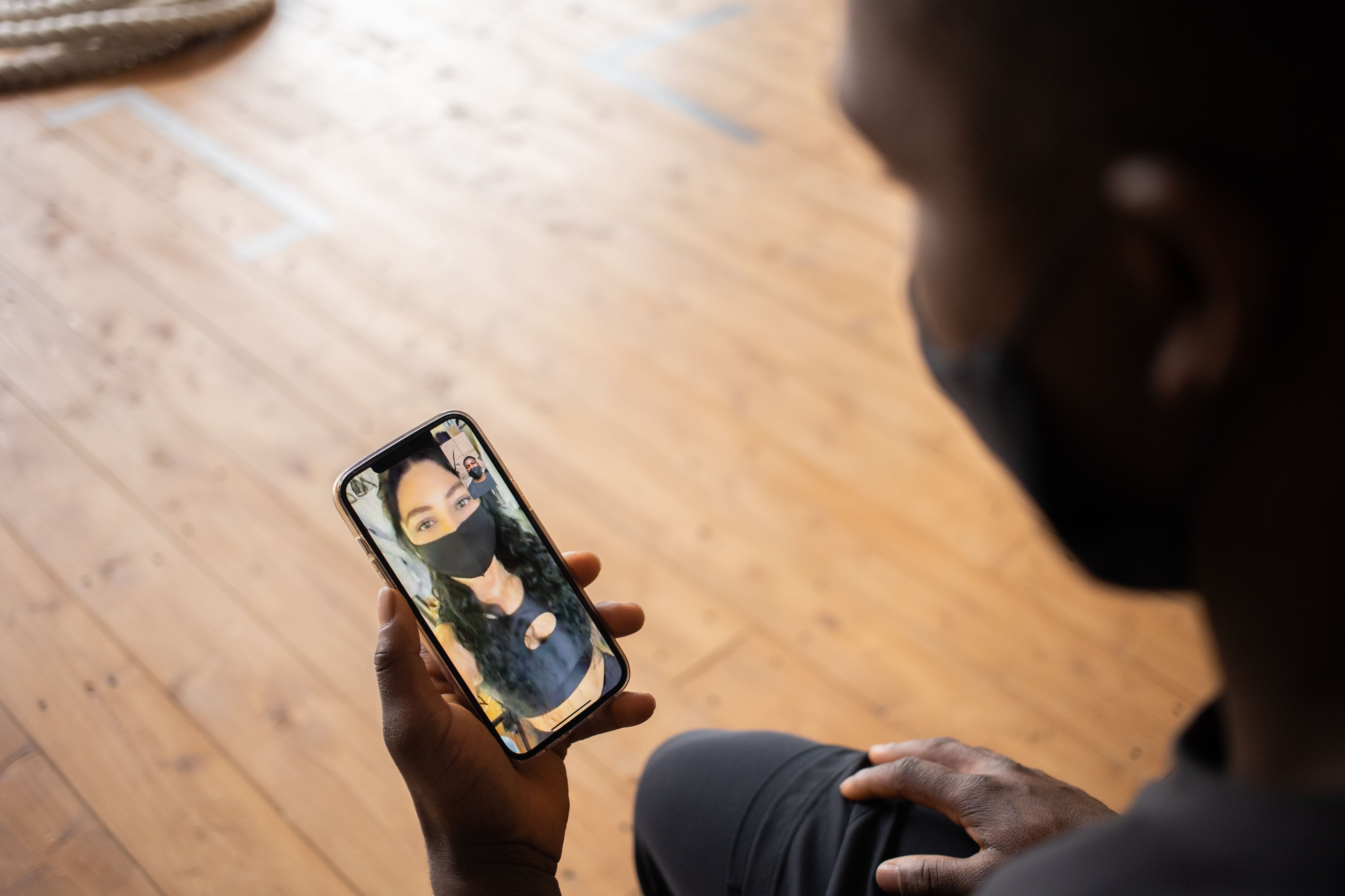 Two people connecting through a video chat on their phones